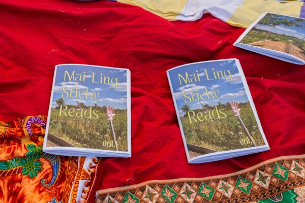 Two booklets of Mai Ling Sticky Reads lay on top of a red cloth.