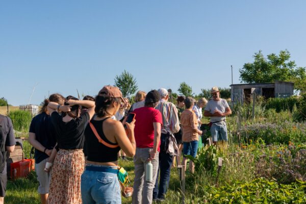 A group of people on a walking tour in an agricultural field