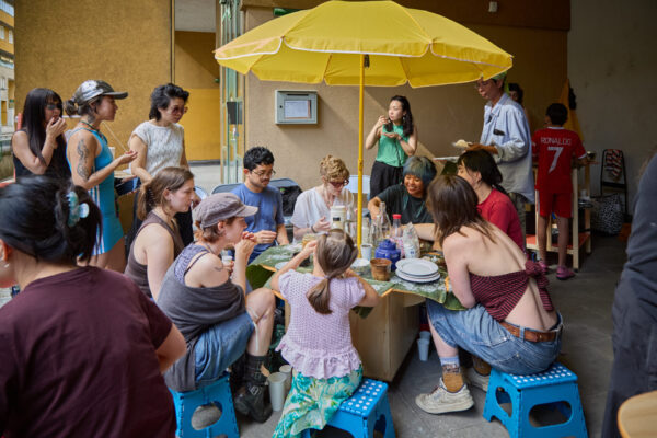 A bunch of people gathering around a mobile kitchen